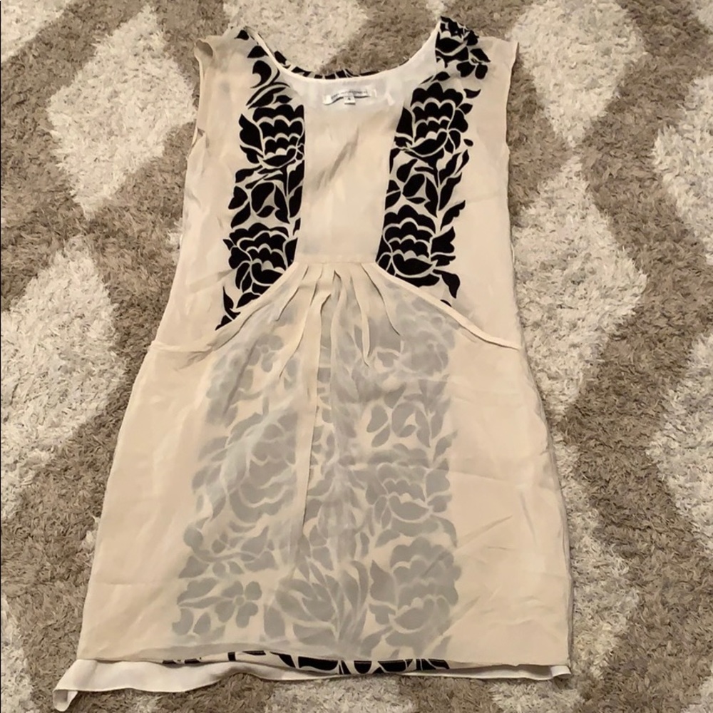 Dress with black flower front on sides.